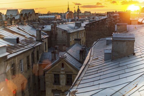 Rooftops historic center St. Petersburg during amazing sunset.